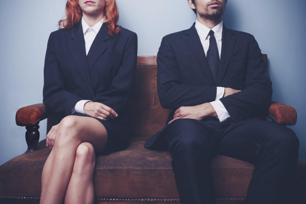 Man and woman waiting to enter a job interview