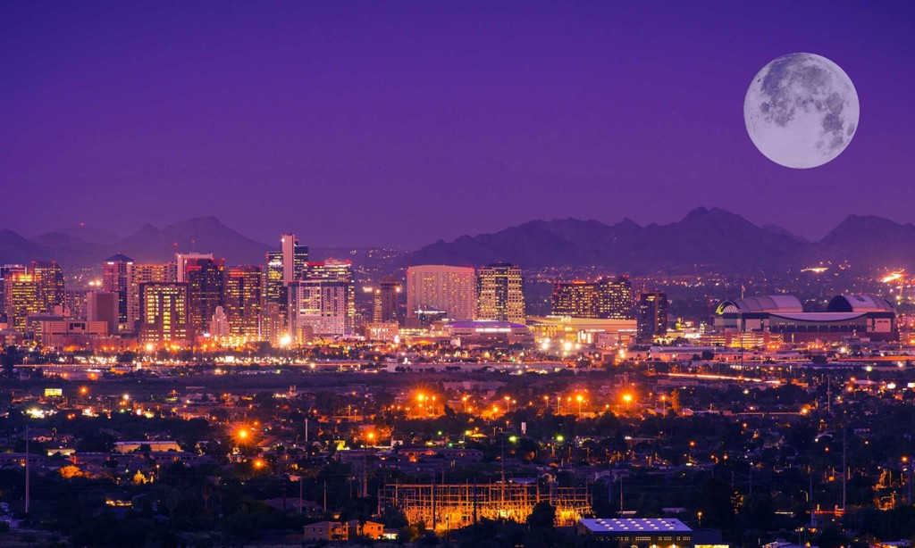Branding Phoenix, Arizona. Looking over the city during the dusk and the moon is rising over the mountains